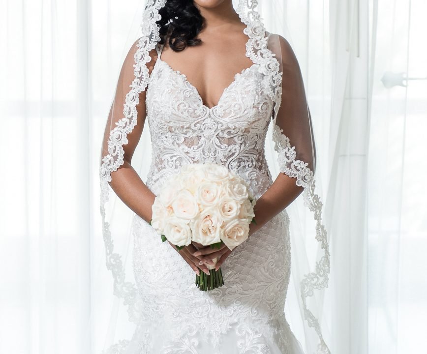 Bride holding a bouquet before her destination wedding ceremony at the Hard Rock Hotel in Punta Cana, photographed by Alito Photography.