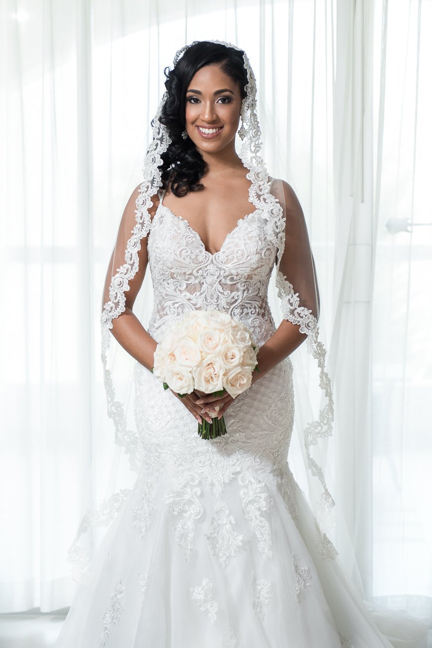 Bride holding a bouquet before her destination wedding ceremony at the Hard Rock Hotel in Punta Cana, photographed by Alito Photography.