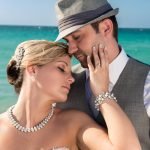 Bride leaning her head against groom’s chest, eyes closed, touching his face softly, romantic wedding portrait in Miami.