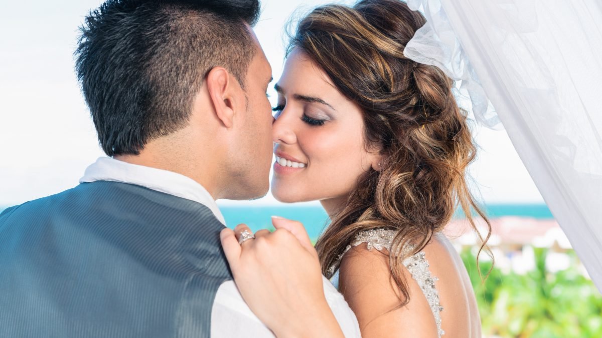 Bride about to kiss groom close-up, romantic Miami wedding photography.