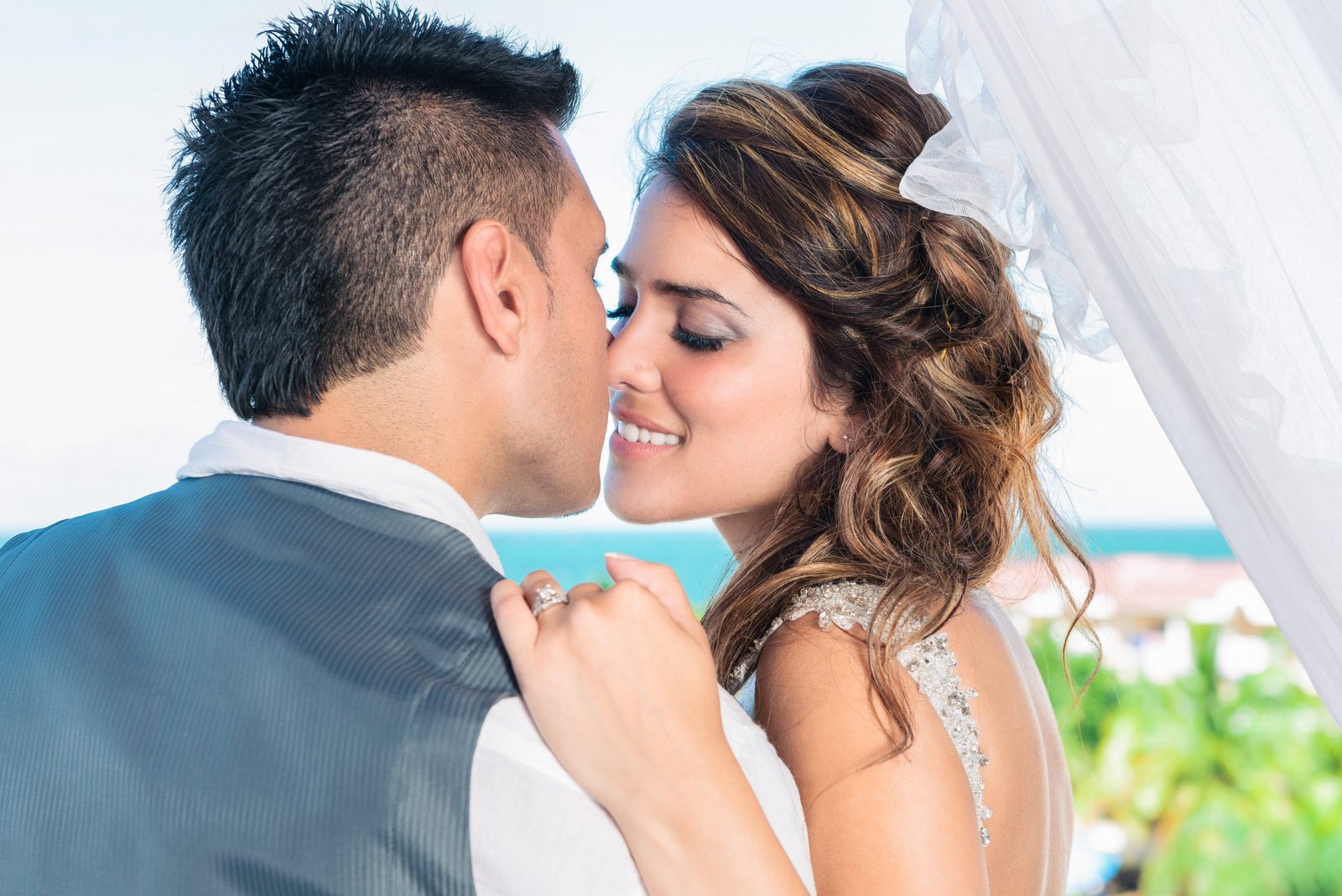 Bride about to kiss groom close-up, romantic Miami wedding photography.