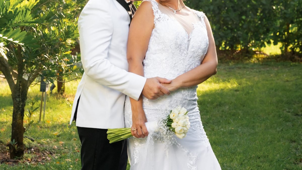 Wedding couple walking through the gardens of a Redland venue in Miami, captured by Alito Photography with a Nikon Z8 and 85mm lens, telling their unique love story.