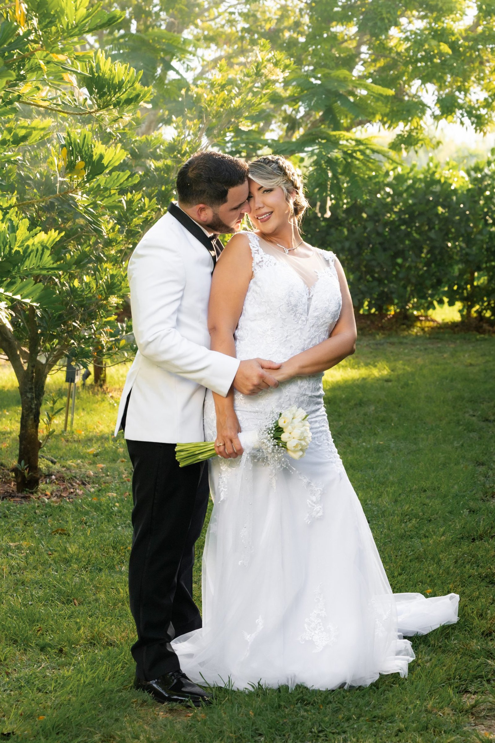 Wedding couple walking through the gardens of a Redland venue in Miami, captured by Alito Photography with a Nikon Z8 and 85mm lens, telling their unique love story.