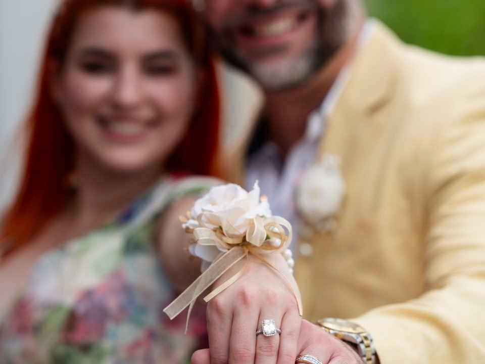 Engaged couple standing together and showing their engagement rings during a Miami engagement photoshoot by Alito Photography.