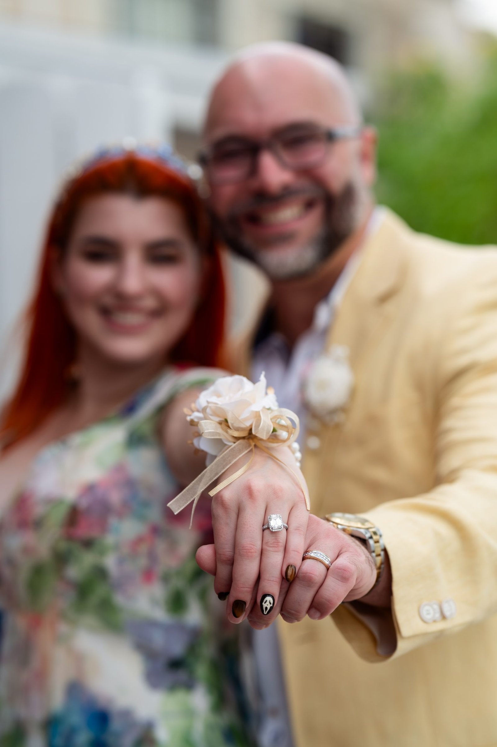 Engaged couple standing together and showing their engagement rings during a Miami engagement photoshoot by Alito Photography.