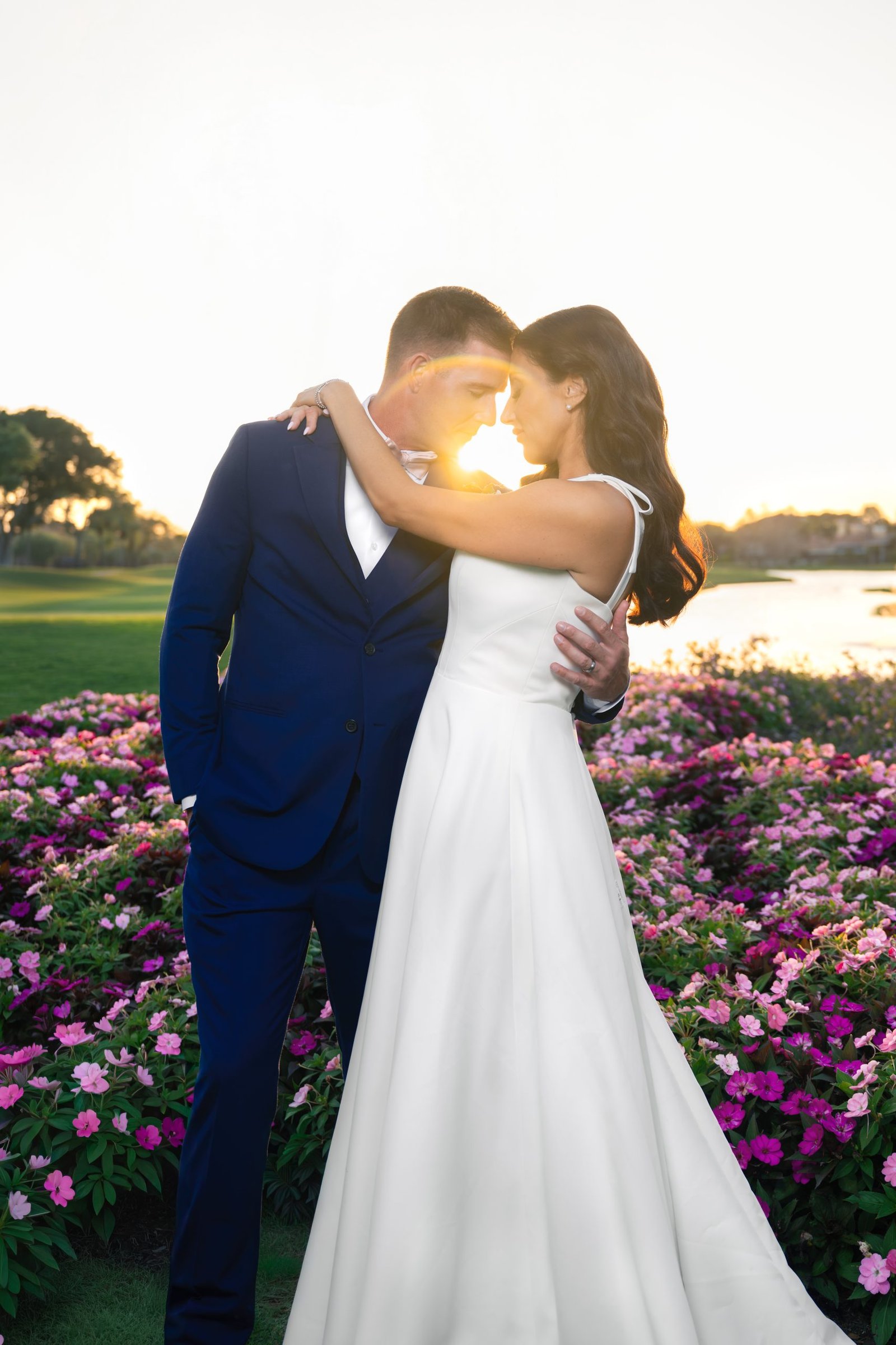 Bride and groom kissing with soft sun flare forming a circle of light during their wedding at The Club at Ibis in West Palm Beach, captured by Miami wedding photographer Alito Photography.