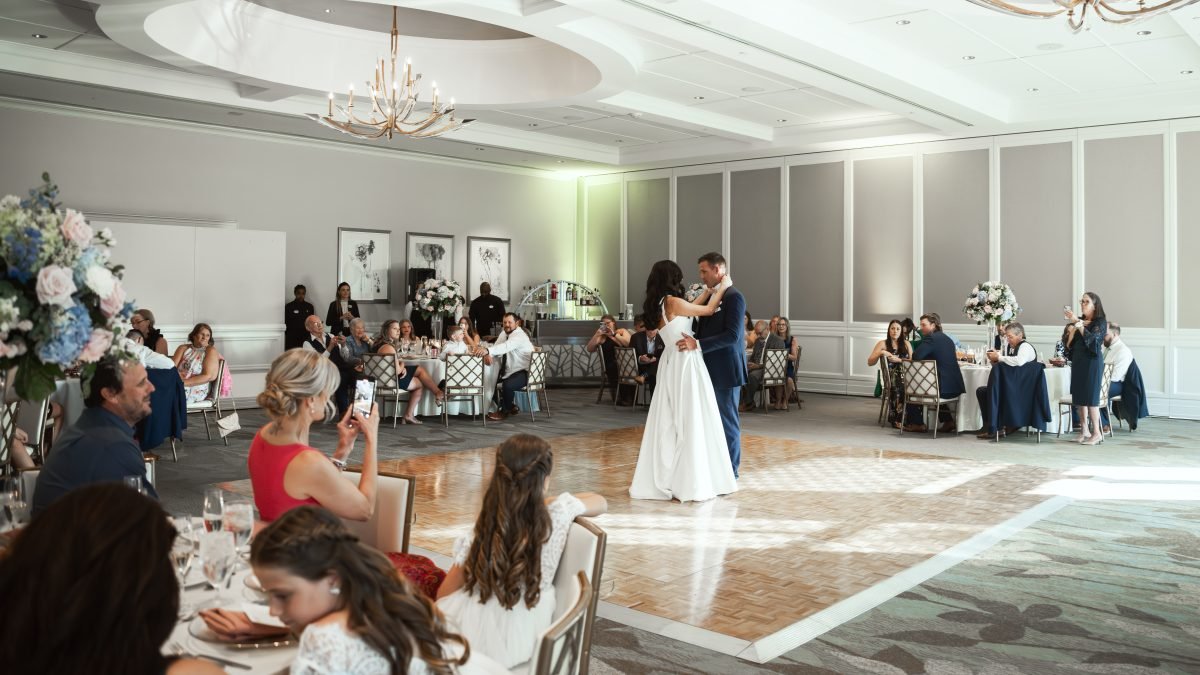 Bride and groom first dance at The Club at Ibis West Palm Beach with family watching – luxury wedding photography by Alito Photography