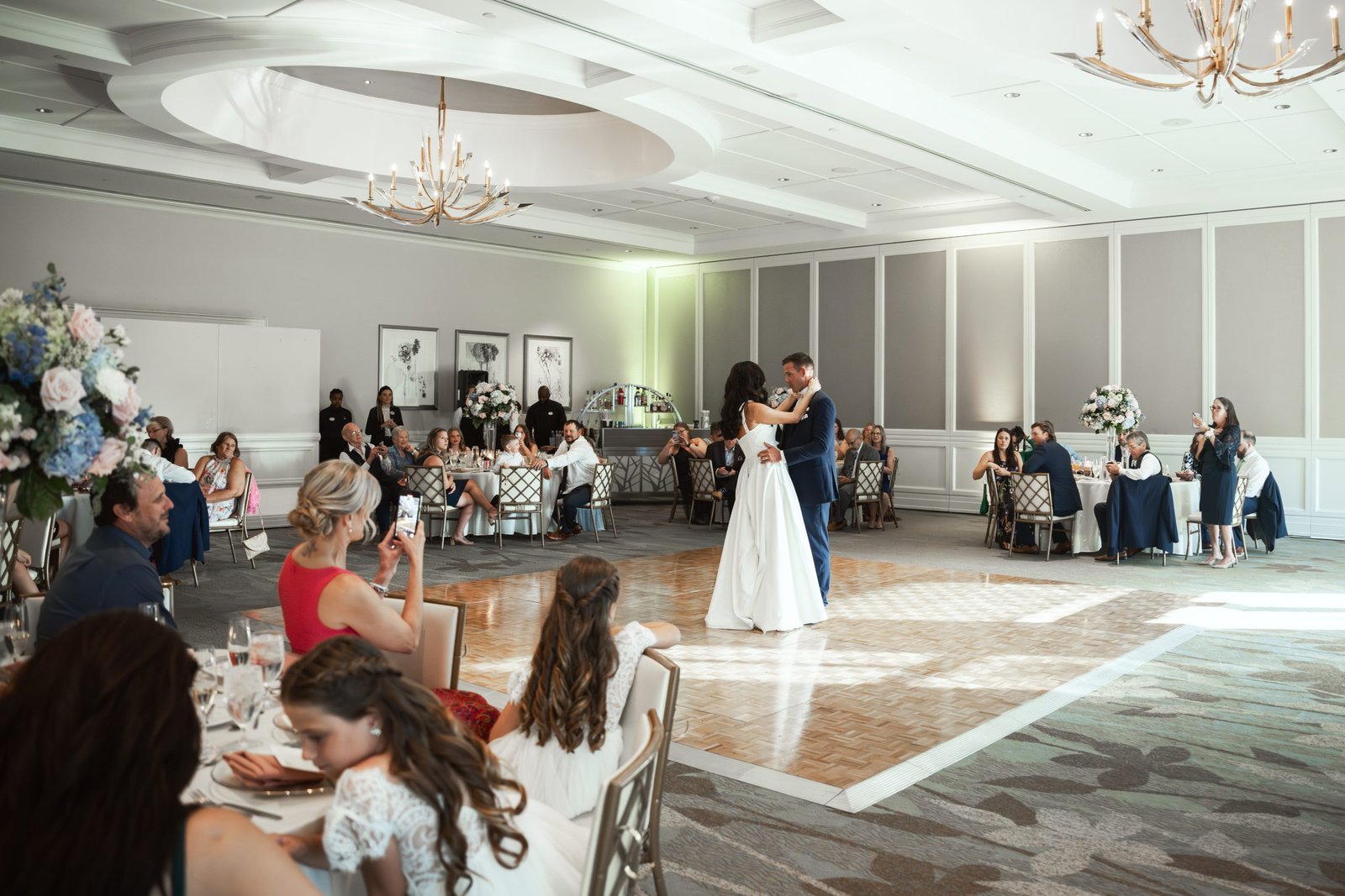 Bride and groom first dance at The Club at Ibis West Palm Beach with family watching – luxury wedding photography by Alito Photography