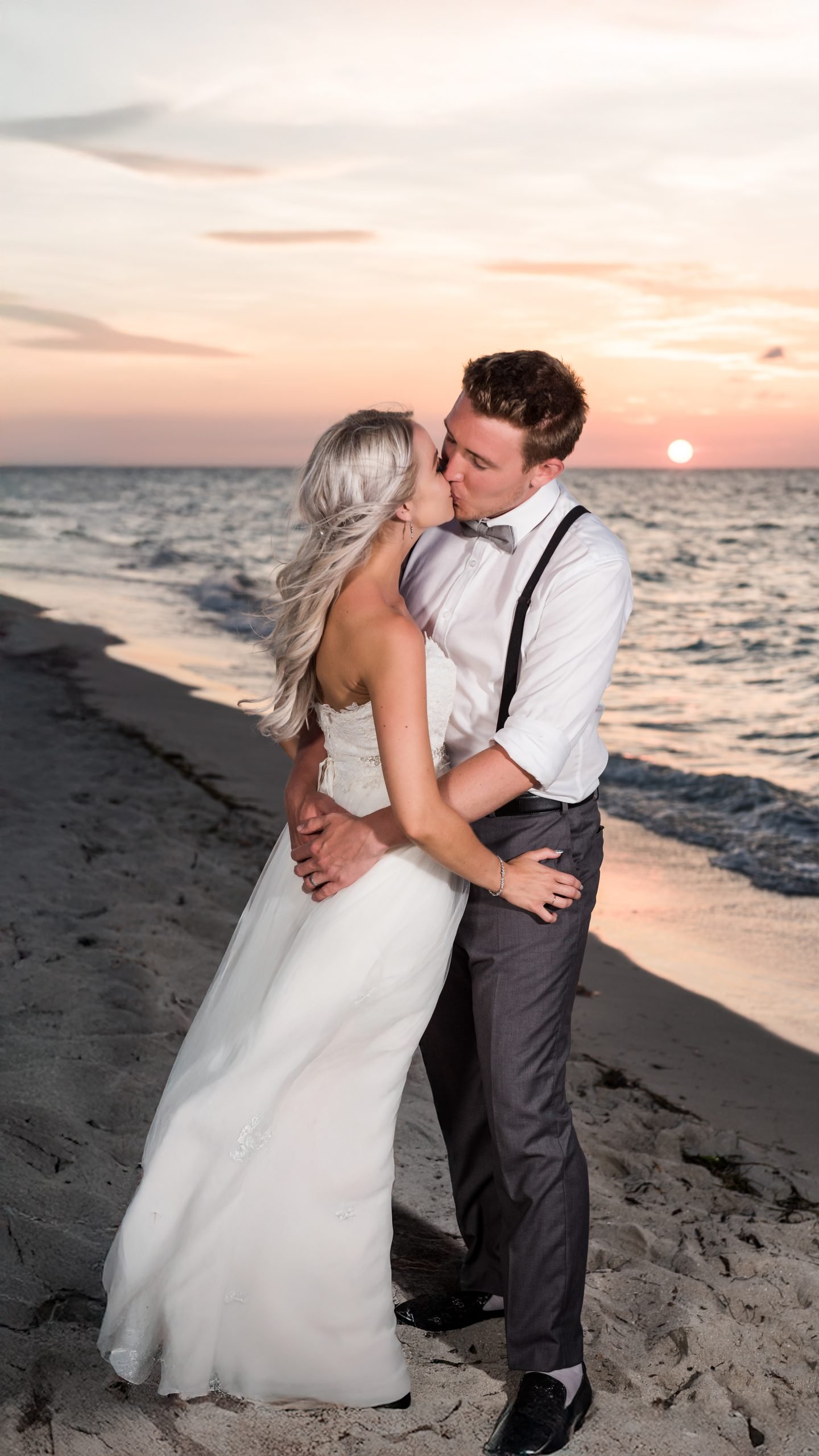 Newlyweds kissing on a Miami beach at sunset, photographed by Alito Photography for a South Florida wedding.