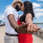 Destination wedding couple during engagement photo session proudly showing their engagement rings, photographed by Miami wedding and engagement photographer Alito Photography.