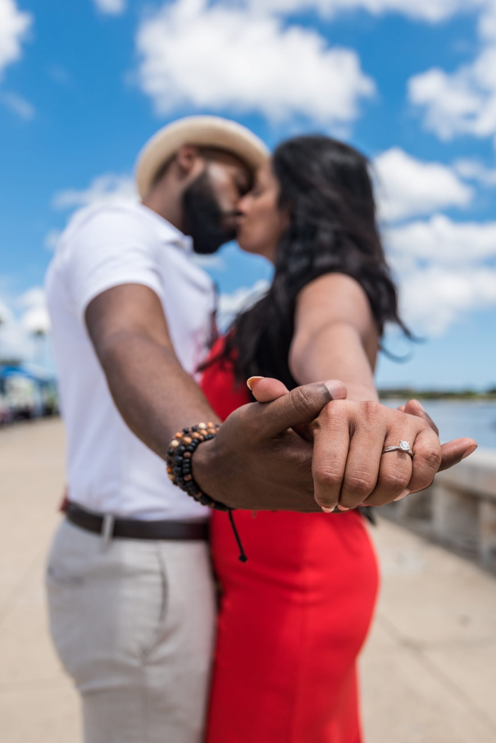 Destination wedding couple during engagement photo session proudly showing their engagement rings, photographed by Miami wedding and engagement photographer Alito Photography.