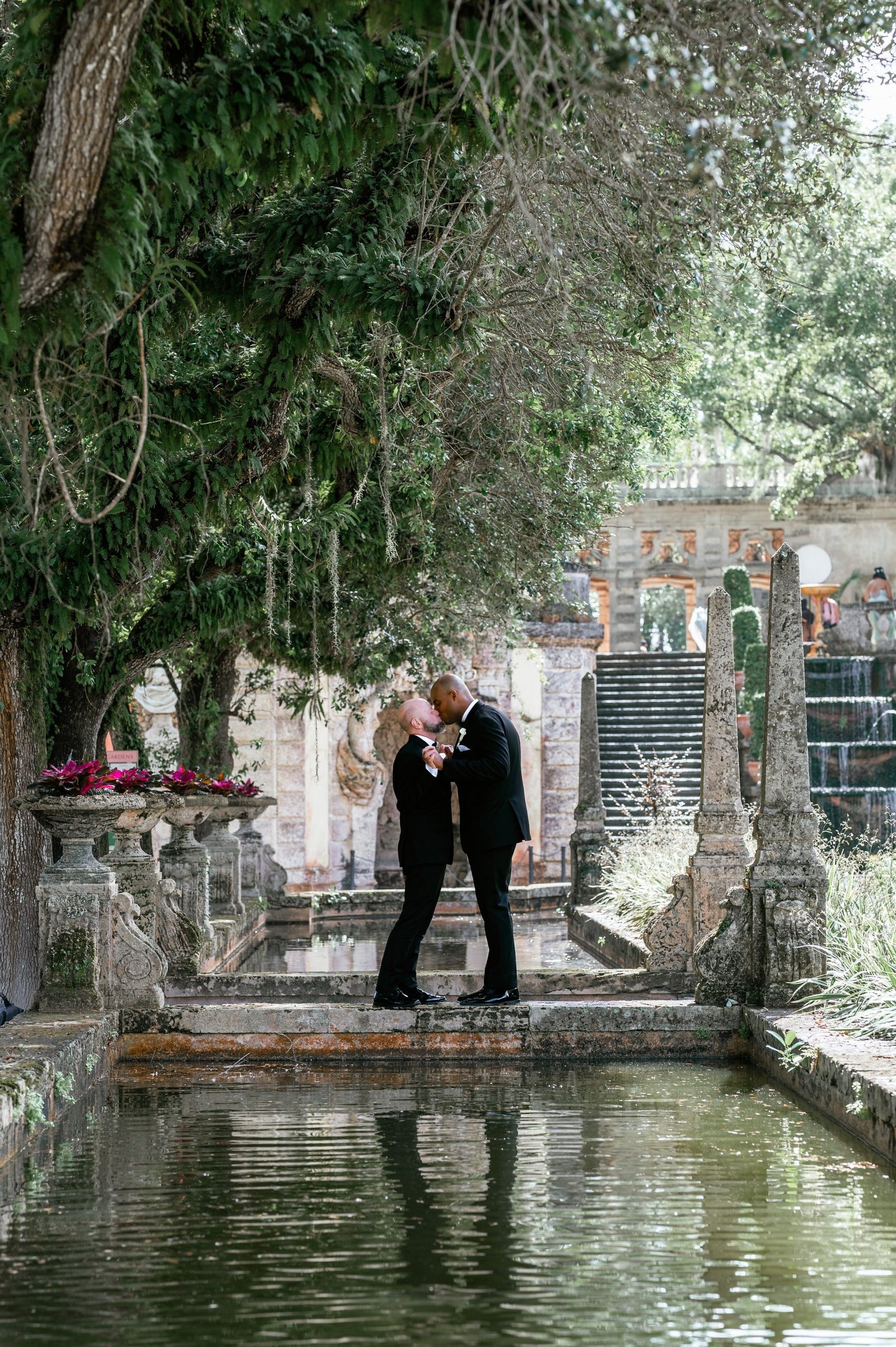 LGBTQ couple wedding portraits at Vizcaya Museum and Gardens captured by Alito Photography, featuring romantic poses among historic gardens and European-style architecture.