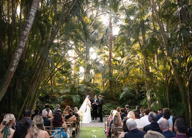 Outdoor wedding ceremony under the palm trees at The Cooper Estate in Redland, Miami, photographed by Alito Photography