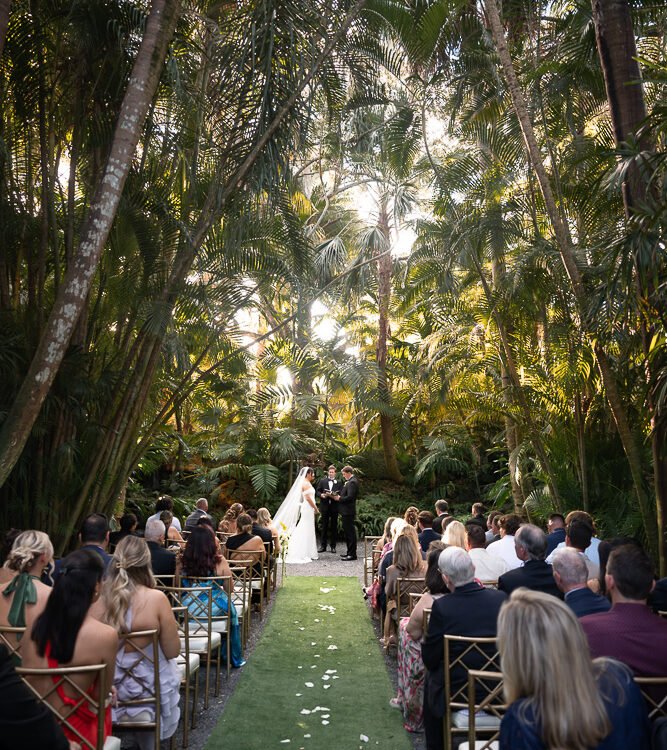Outdoor wedding ceremony under the palm trees at The Cooper Estate in Redland, Miami, photographed by Alito Photography